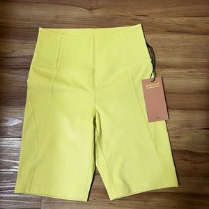 Yellow Girlfriend Collective biker shorts.